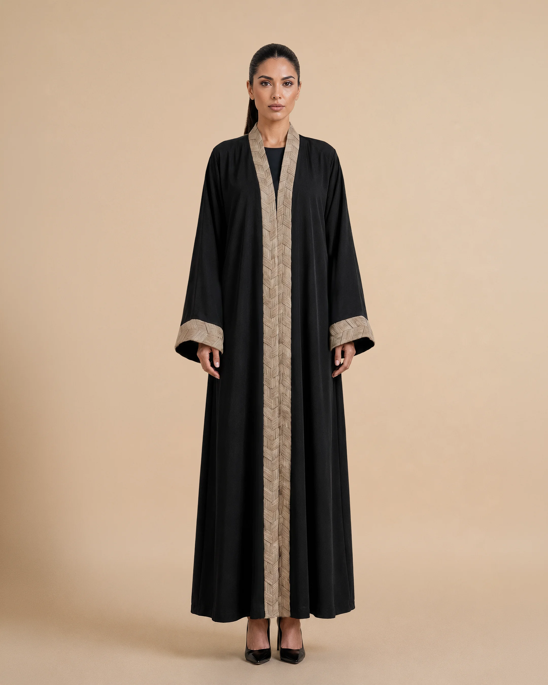 Belgravia Abaya luxury abaya in Black, front view, trim inspired by traditional Khous weaving, Emirati heritage and Abu Dhabi culture. Bint Saeed Abu Dhabi, UAE.