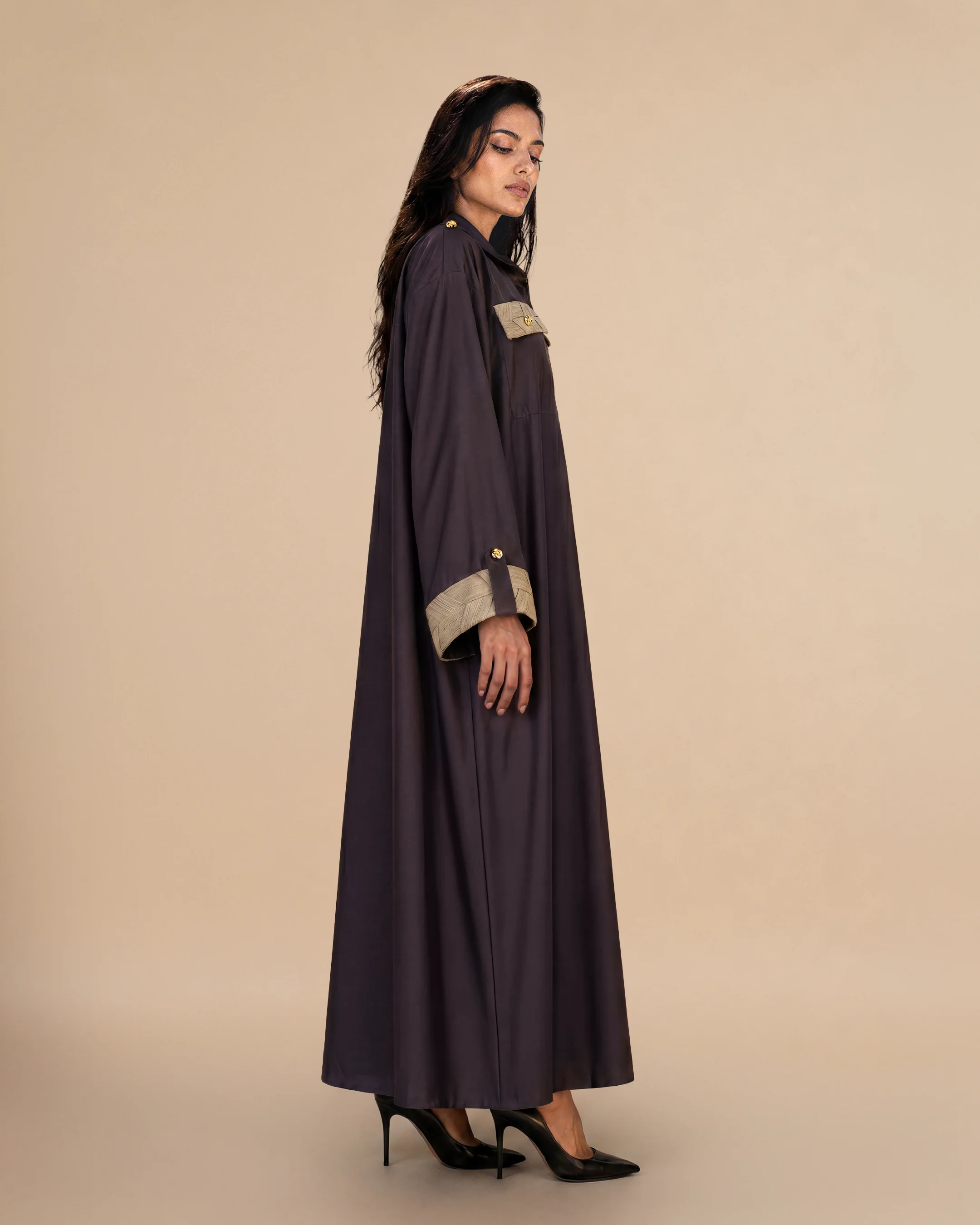 Knightsbridge Abaya Jacket luxury abaya in Dark Brown, side view, trim inspired by traditional Khous weaving, Emirati heritage and Abu Dhabi culture. Bint Saeed Abu Dhabi, UAE.