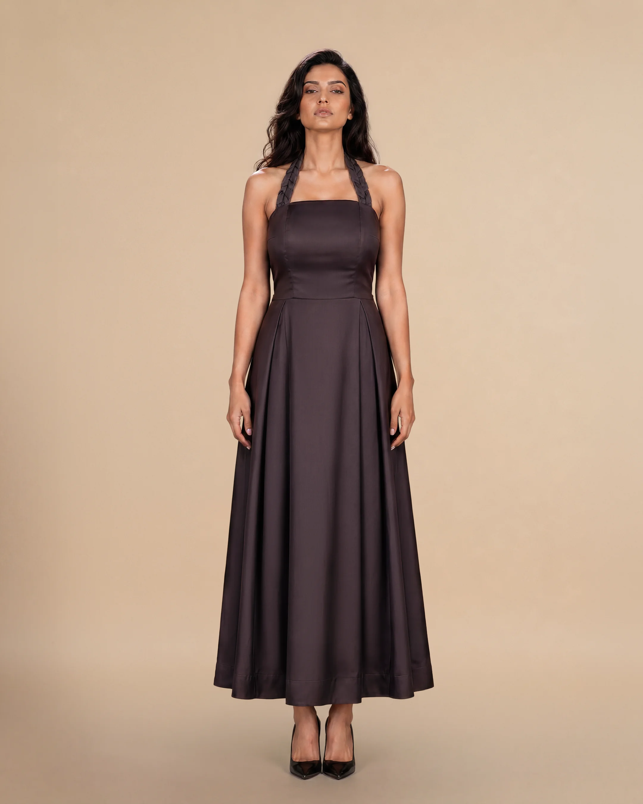 Knightsbridge Dress luxury dress in Dark Brown, front view, trim inspired by traditional Khous weaving, Emirati heritage and Abu Dhabi culture. Bint Saeed Abu Dhabi, UAE.