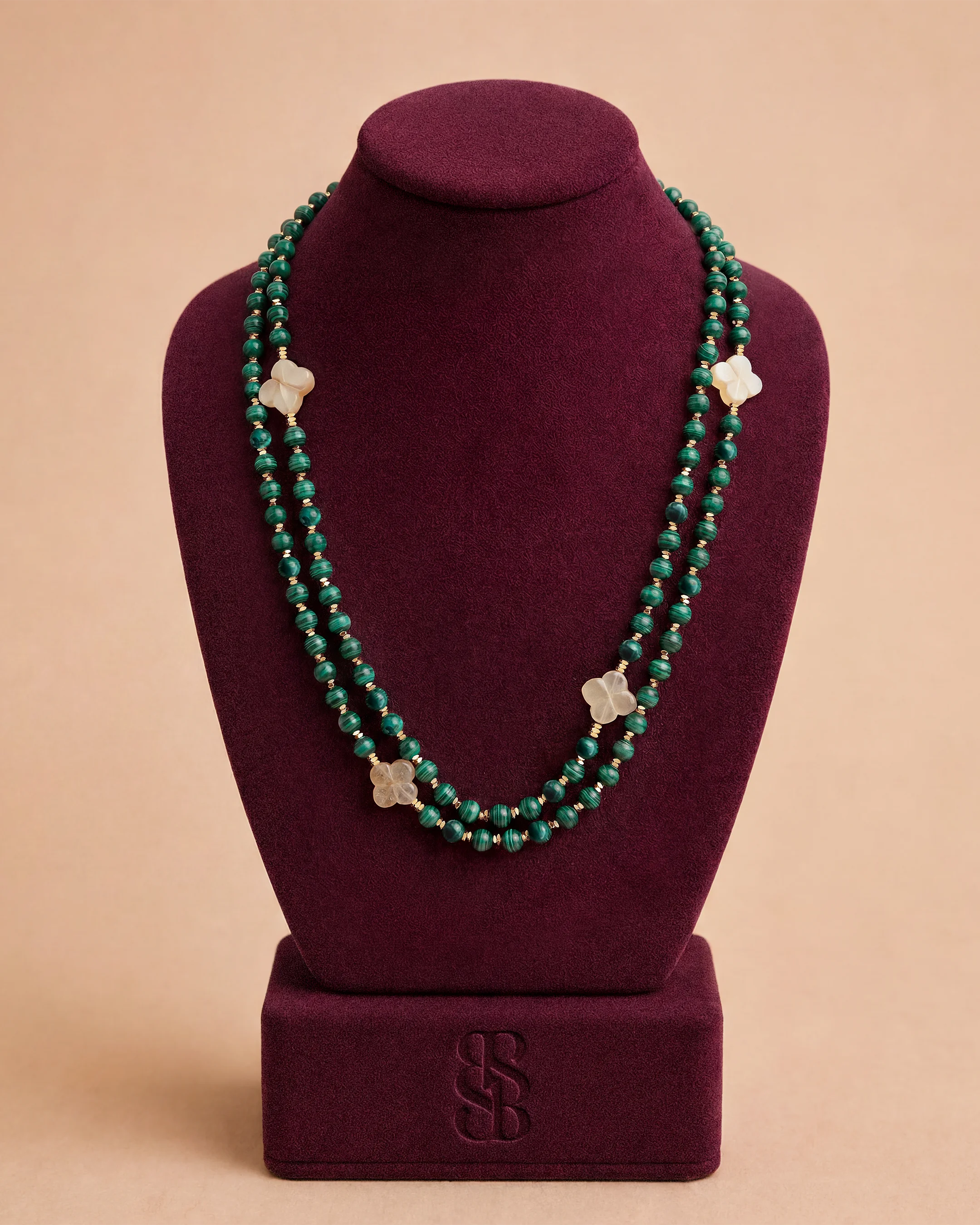 Al Ain Oasis Necklace - Malachite by Bint Saeed: hand-strung natural malachite beads, Carnelian Al Ain Rosette and 18K gold-plated signature clasp — luxury stone bead necklace, handcrafted in Abu Dhabi, United Arab Emirates. Worldwide shipping. Bint Saeed Abu Dhabi, United Arab Emirates.