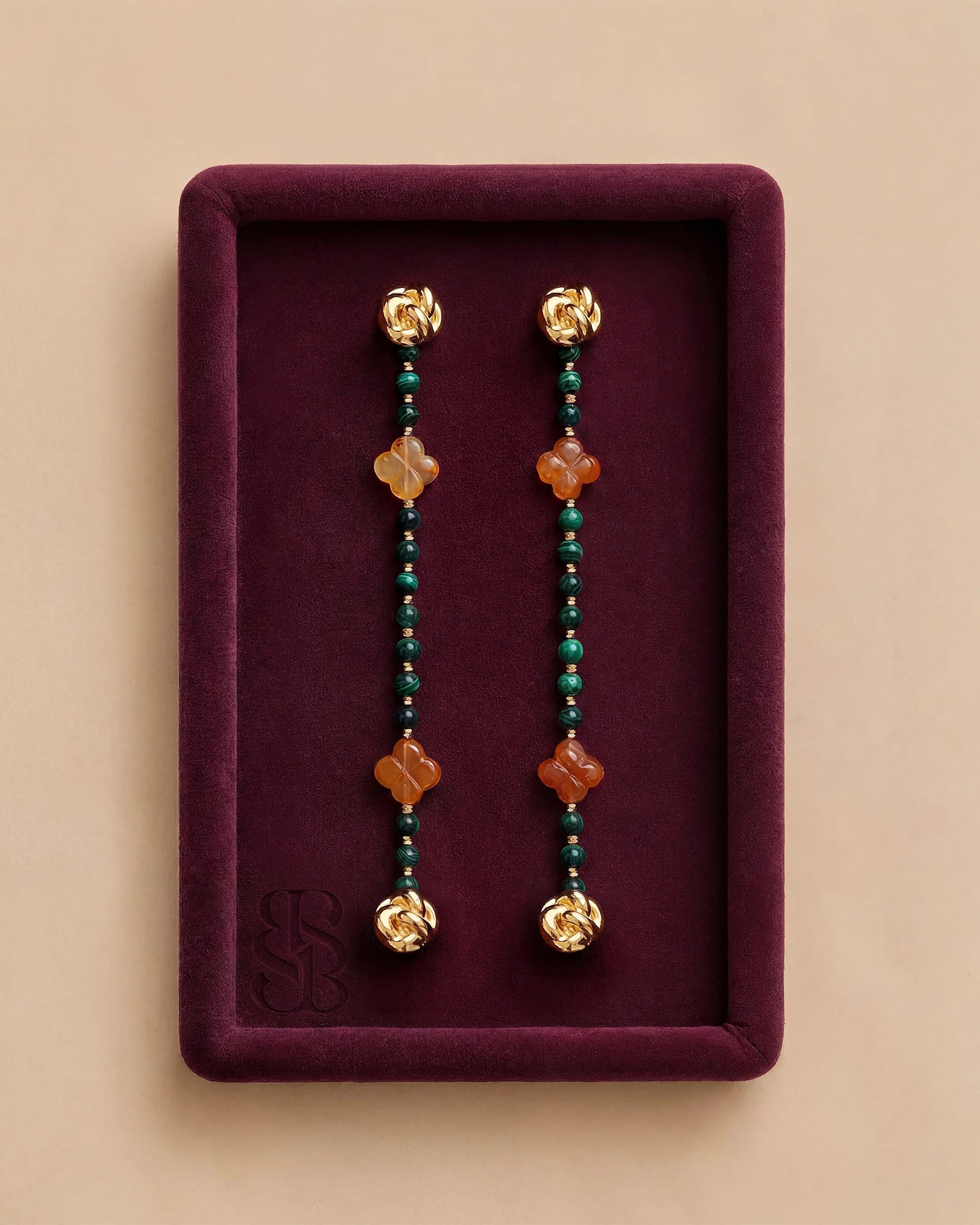 Malachite natural stone bead abaya strand, deep green banded malachite and carnelian beads with 18K gold clip — signature accent for Marylebone Abaya, pairs with Al Ain Oasis Necklace - Malachite. Bint Saeed Abu Dhabi, United Arab Emirates.