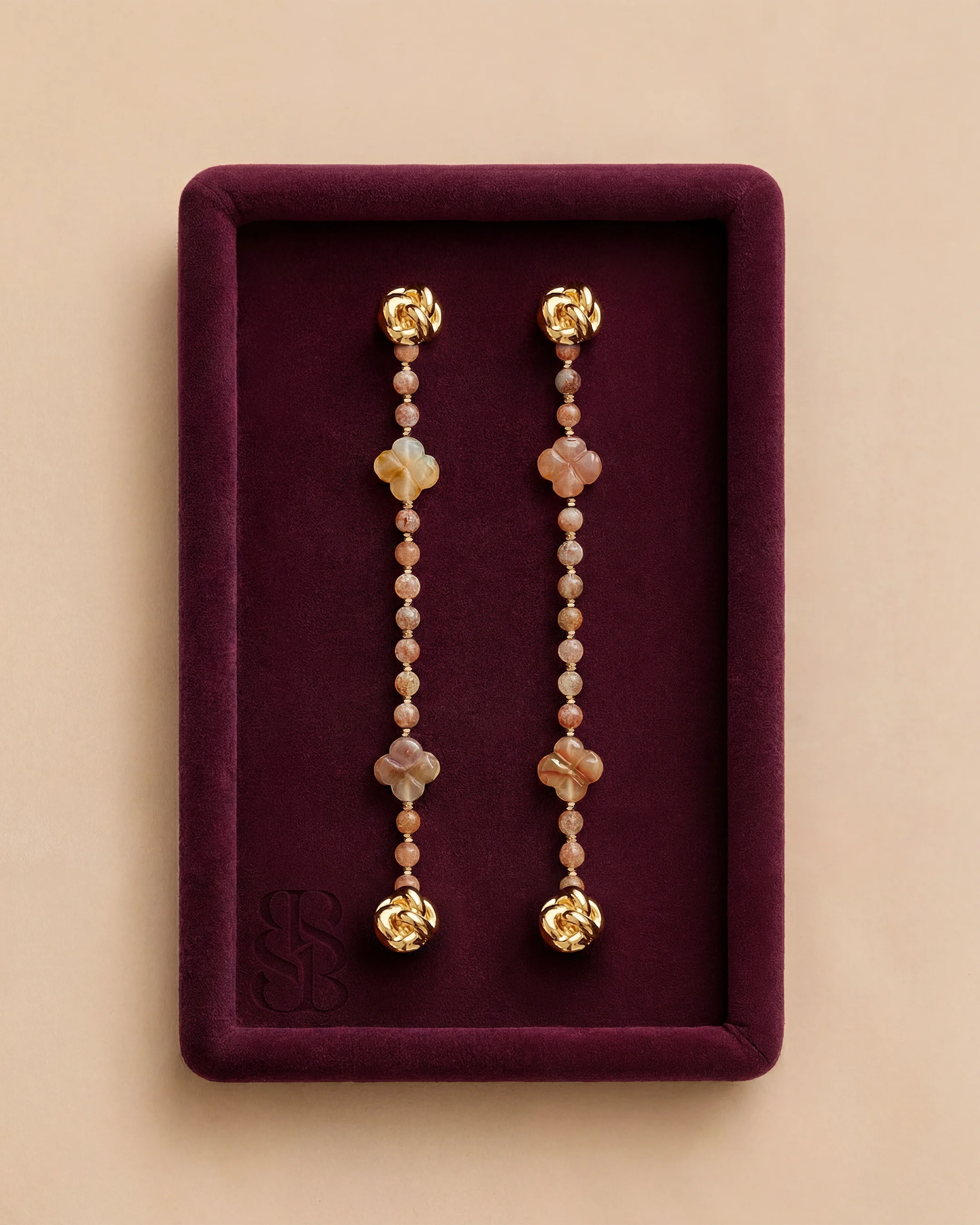 Sunstone natural stone bead abaya strand, warm peach-orange sunstone beads with 18K gold clip — accent for Marylebone Abaya, pairs with Al Ain Oasis Necklace - Sunstone and pearl earrings. Bint Saeed Abu Dhabi, United Arab Emirates.