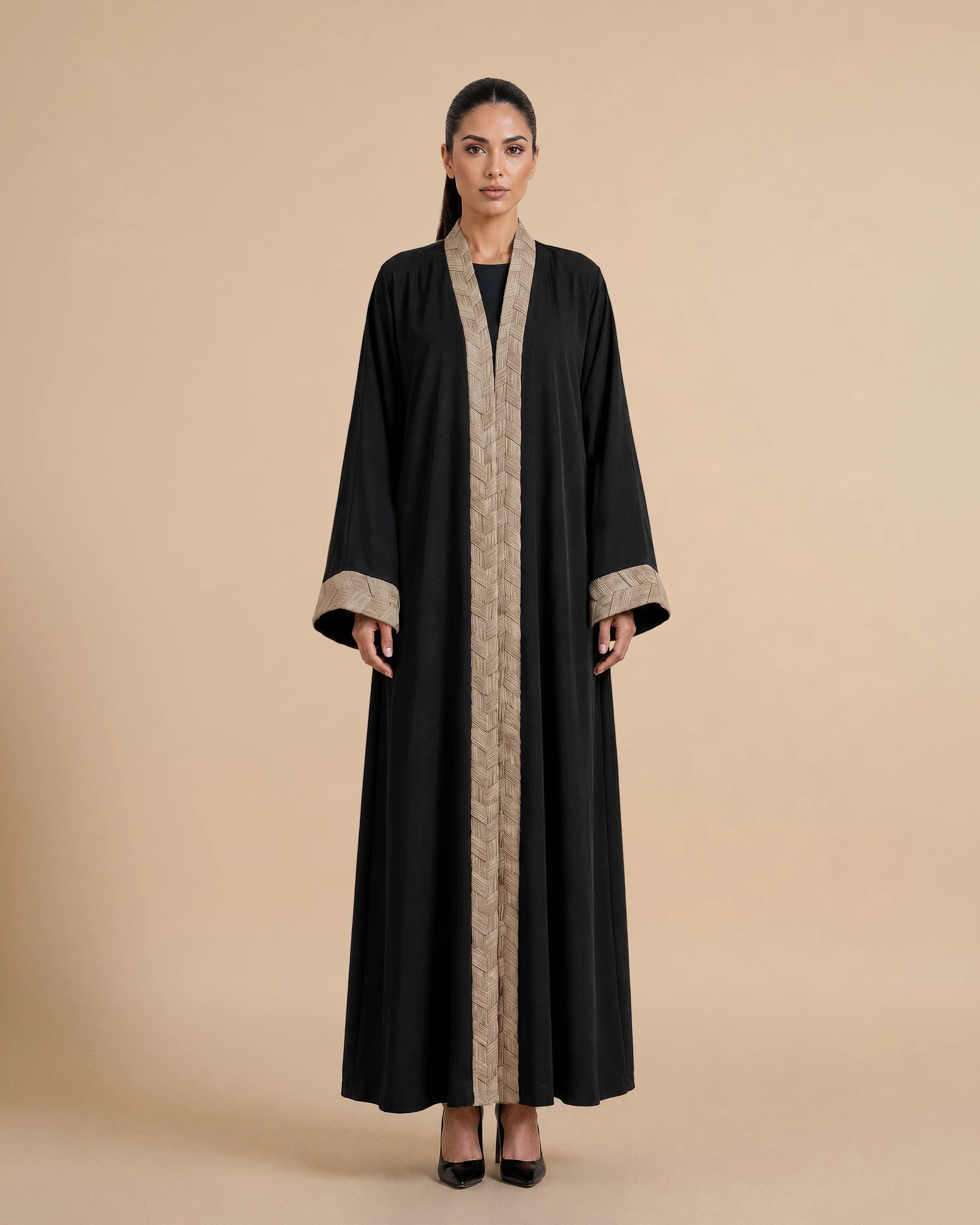 Belgravia Abaya luxury abaya in Black, front view, trim inspired by traditional Khous weaving, Emirati heritage and Abu Dhabi culture. Bint Saeed Abu Dhabi, UAE.
