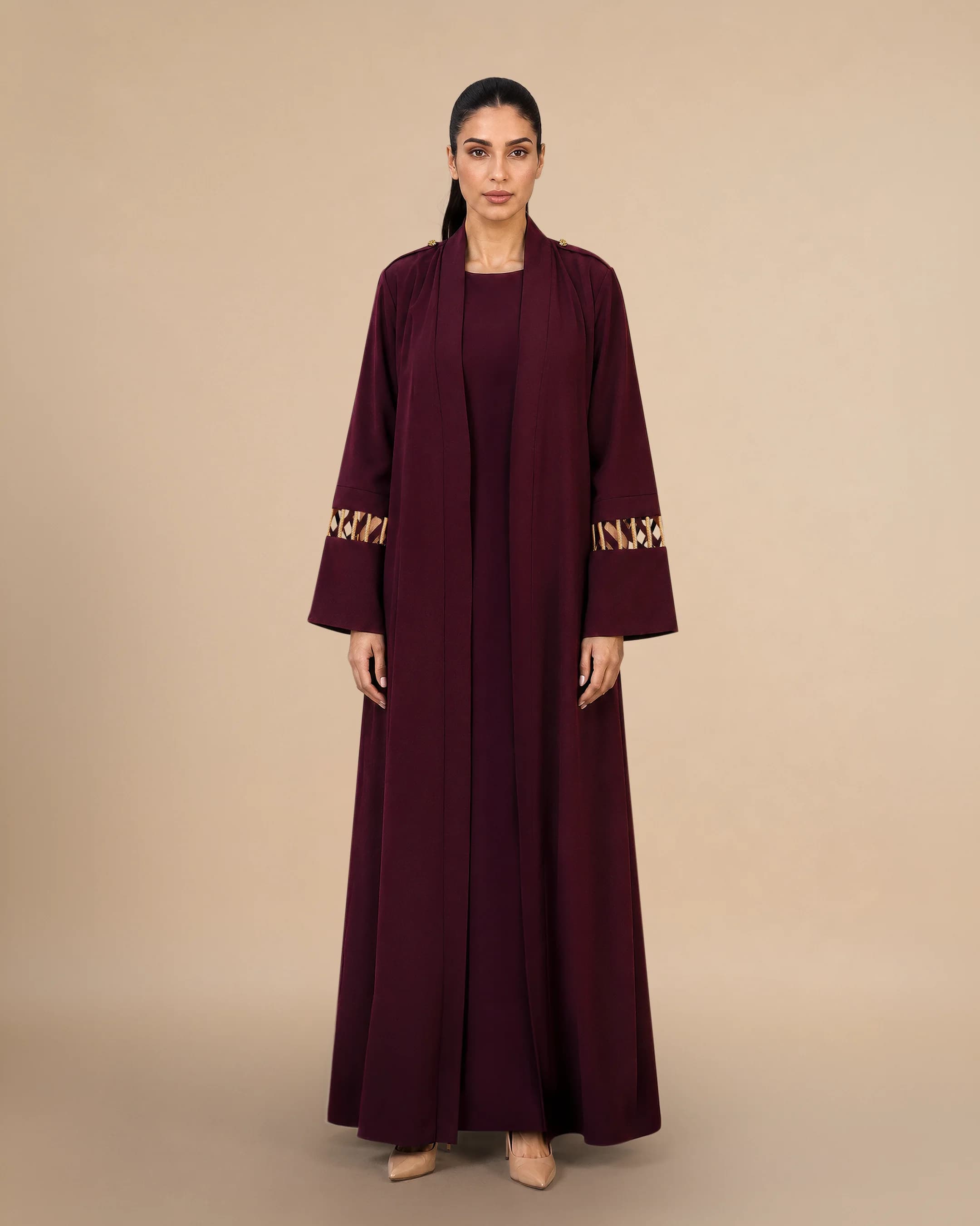 Covent Garden Abaya luxury abaya in Burgundy, front view, traditional Al Talli trim celebrating Emirati heritage and Abu Dhabi culture. Bint Saeed Abu Dhabi, UAE.