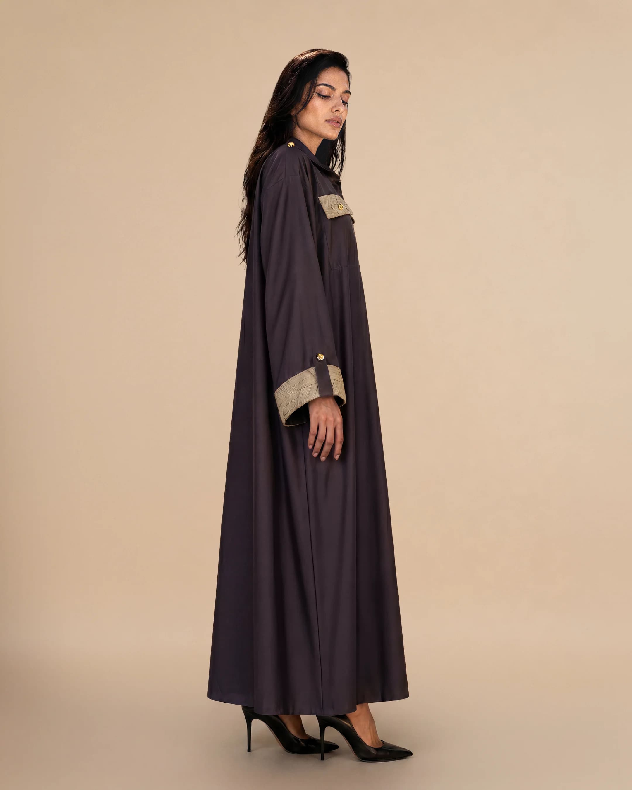 Knightsbridge Abaya Jacket luxury abaya in Dark Brown, side view, trim inspired by traditional Khous weaving, Emirati heritage and Abu Dhabi culture. Bint Saeed Abu Dhabi, UAE.
