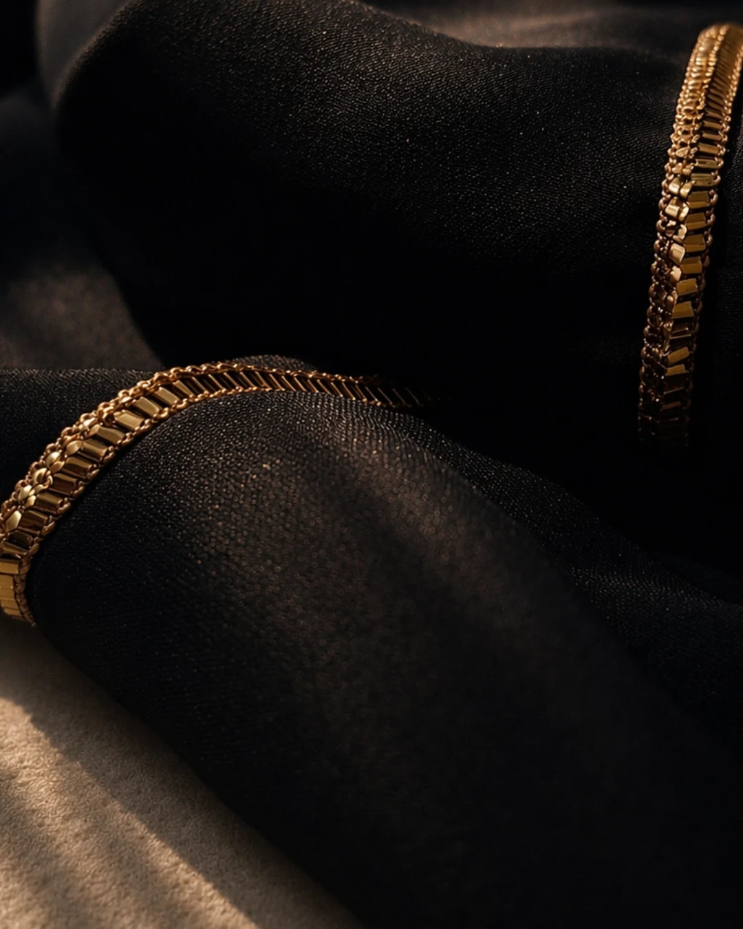 Gold Al Talli stitch detail on black Hampstead dress fabric. Bint Saeed Abu Dhabi, United Arab Emirates.